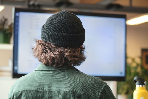 Technical engineer sitting at computer wondering how to upload certificates to his load balancer